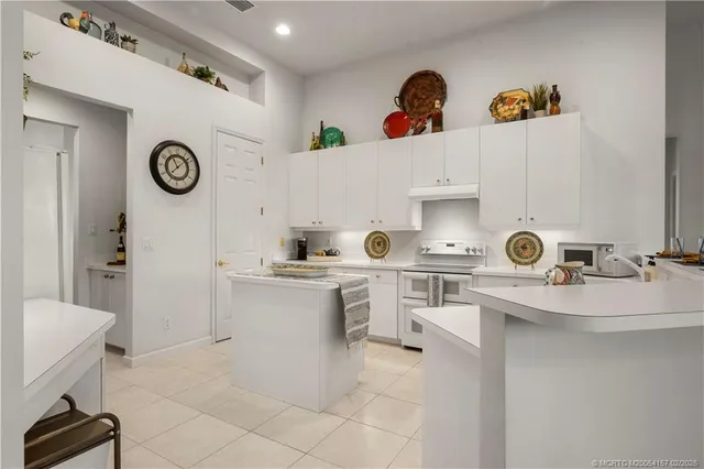 a kitchen with a sink a stove and cabinets