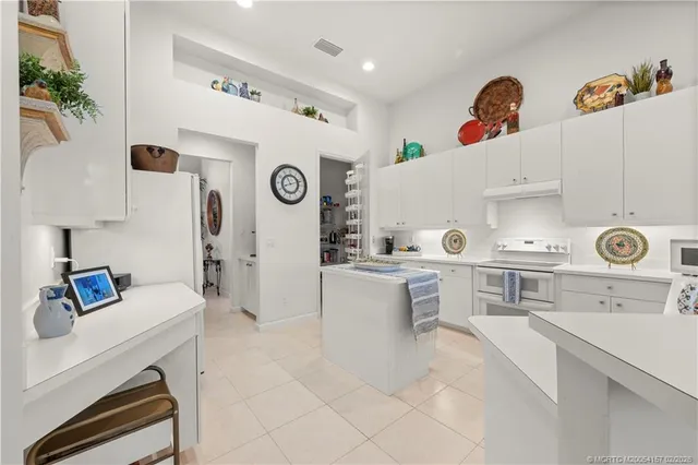 a kitchen with a table and chairs