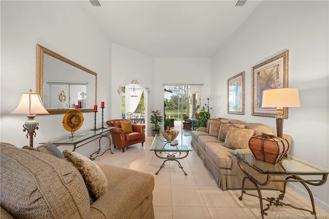 a living room with furniture and a lamp