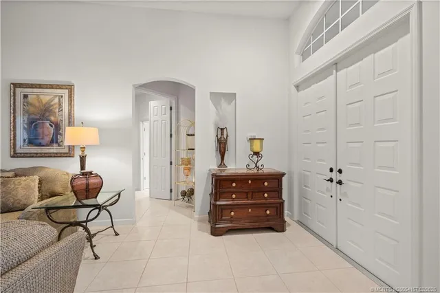 a spacious bedroom with a bed and a chandelier