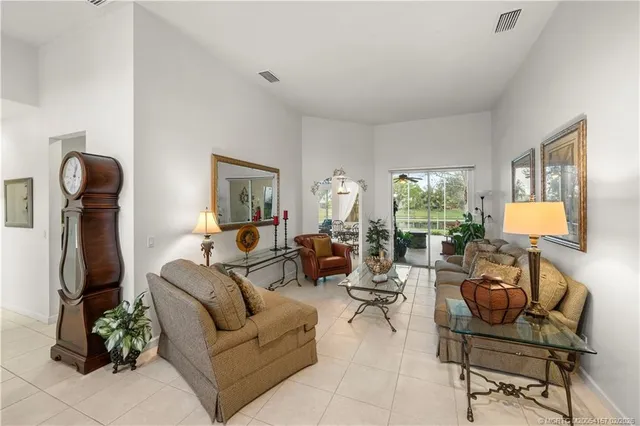 a living room with furniture a window and gym equipment