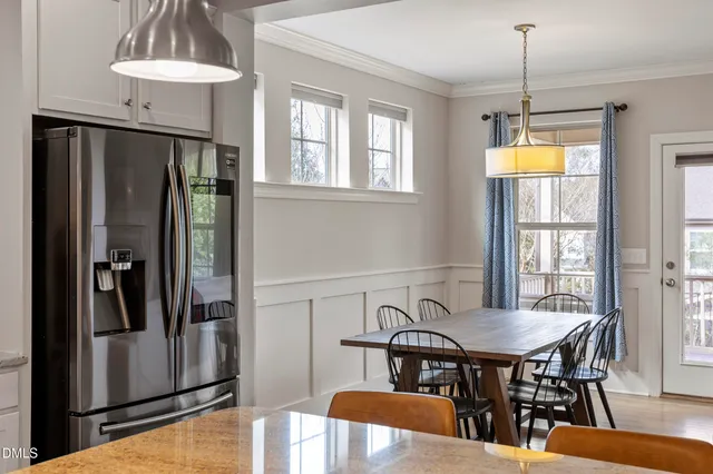 a view of a dining room with furniture and window