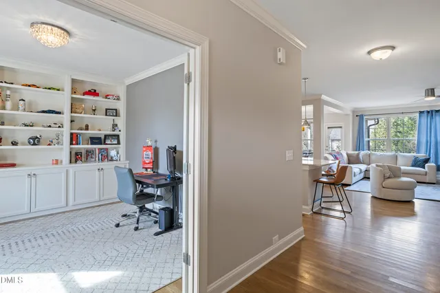 a view of a workspace with furniture and a window