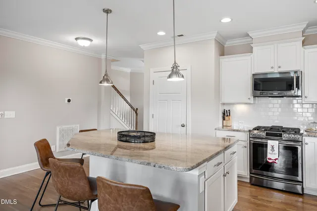 a kitchen with sink cabinets and living room view