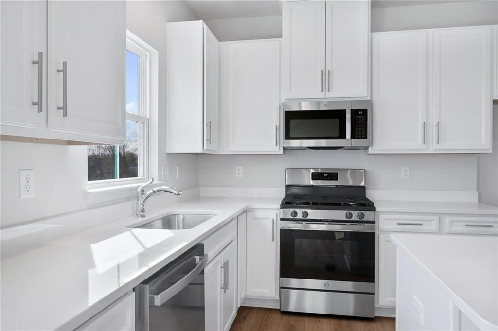 152 Crown Street McKees Rocks, PA 15136 - Photo 15 of 28 a kitchen with cabinets stainless steel appliances a sink and a microwave