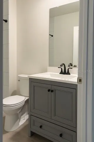 a bathroom with a sink toilet and vanity