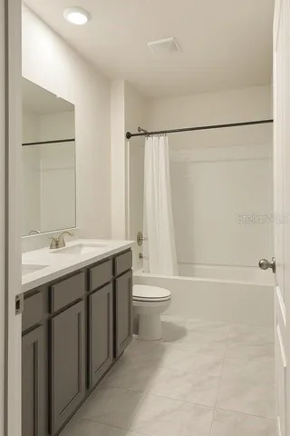 a bathroom with a double vanity sink toilet and shower