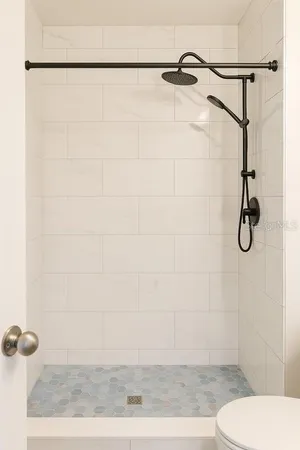 a bathroom with a toilet and a shower