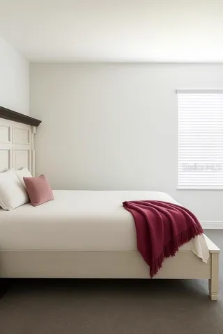 a bedroom with a bed and a night stand