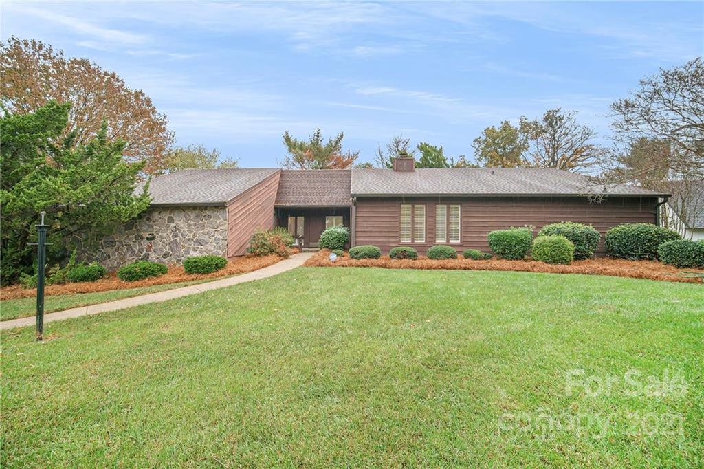 8001 Rising Meadow Road Charlotte, NC 28277 - Photo 1 of 40 a front view of a house with garden
