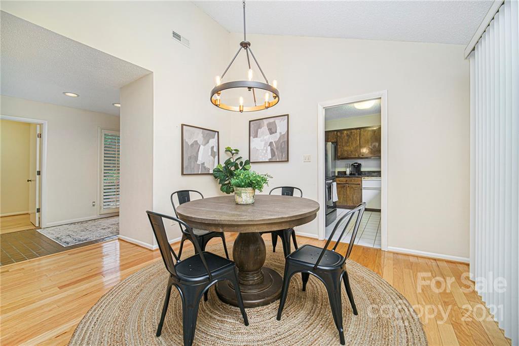 8001 Rising Meadow Road Charlotte, NC 28277 - Photo 13 of 40 a view of a dining room with furniture and wooden floor