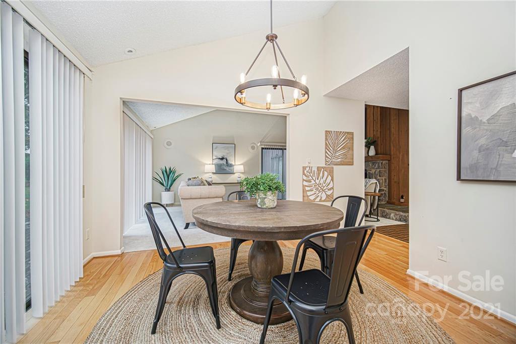 8001 Rising Meadow Road Charlotte, NC 28277 - Photo 14 of 40 a view of a dining room with furniture and wooden floor