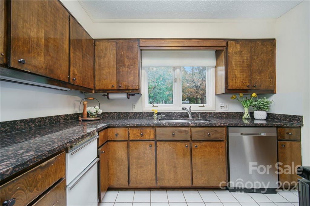 8001 Rising Meadow Road Charlotte, NC 28277 - Photo 15 of 40 a kitchen with granite countertop a sink a stove and cabinets