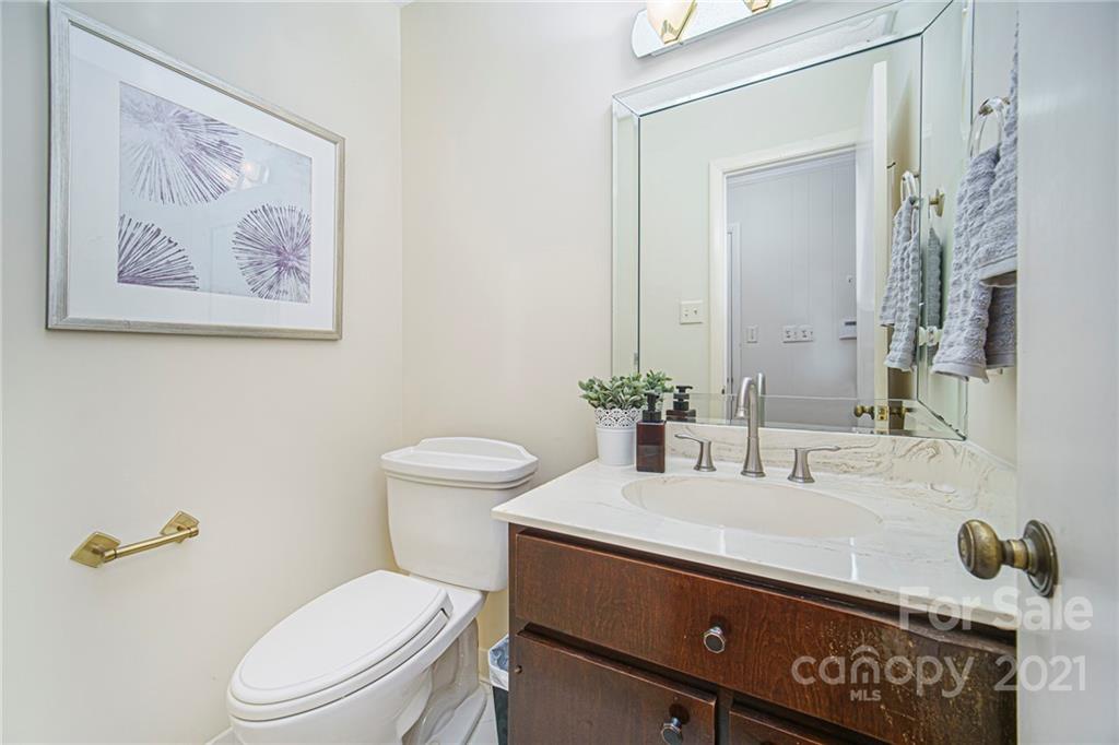 8001 Rising Meadow Road Charlotte, NC 28277 - Photo 24 of 40 a bathroom with a toilet sink and mirror