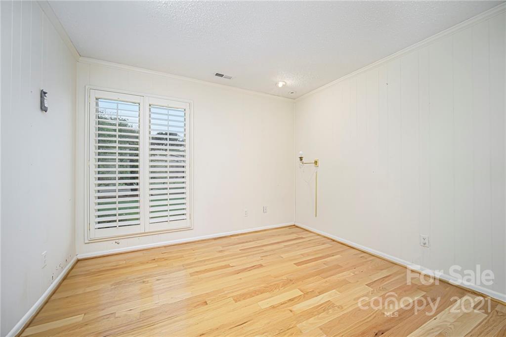 8001 Rising Meadow Road Charlotte, NC 28277 - Photo 25 of 40 a view of empty room with wooden floor and fan