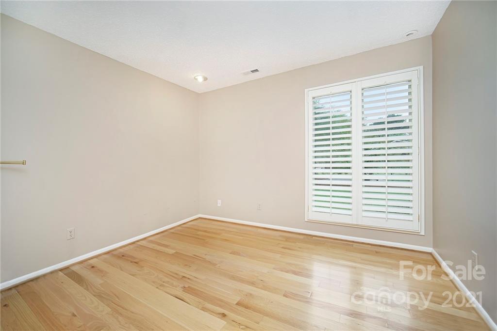 8001 Rising Meadow Road Charlotte, NC 28277 - Photo 26 of 40 a view of an empty room with wooden floor and a window
