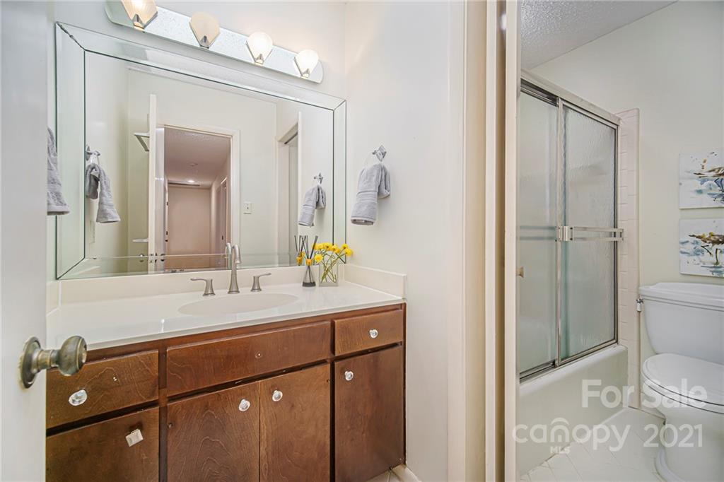 8001 Rising Meadow Road Charlotte, NC 28277 - Photo 27 of 40 a bathroom with a sink and mirror with toilet