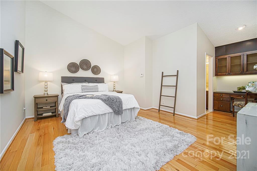 8001 Rising Meadow Road Charlotte, NC 28277 - Photo 28 of 40 a bedroom with a bed and wooden floor