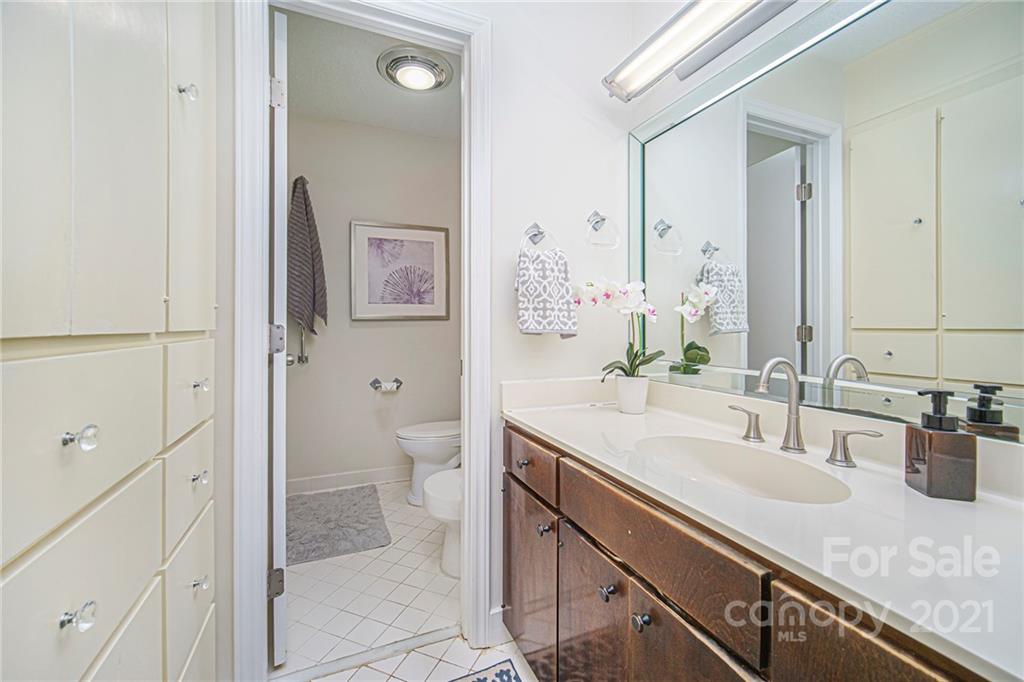 8001 Rising Meadow Road Charlotte, NC 28277 - Photo 32 of 40 a bathroom with a granite countertop sink a toilet and shower
