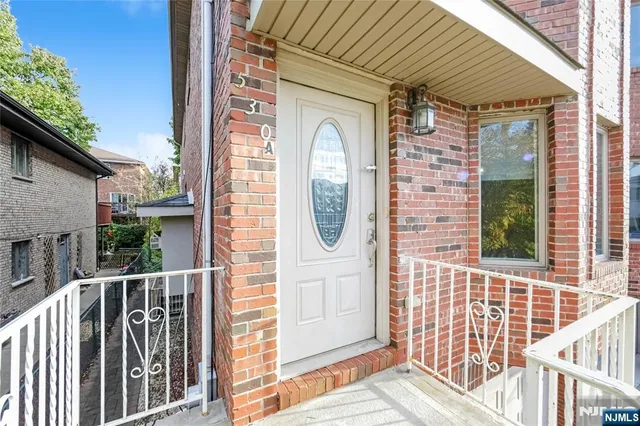 a front view of a house with a iron gate