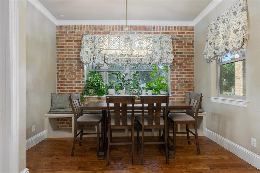 594 Turner Warnell Road Mansfield, TX 76063 - Photo 14 of 38 Dining area with real hardwood floors, a chandelier, and crown molding