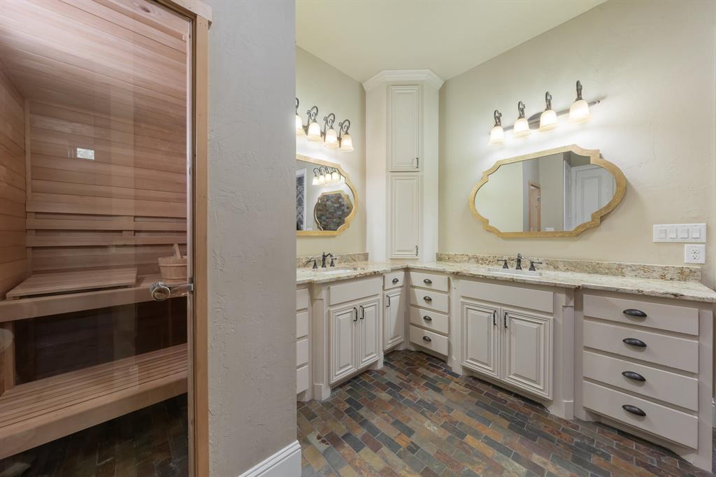 594 Turner Warnell Road Mansfield, TX 76063 - Photo 19 of 38 Primary ensuite with a sauna / steam room, a textured wall, two vanities, and brick floors