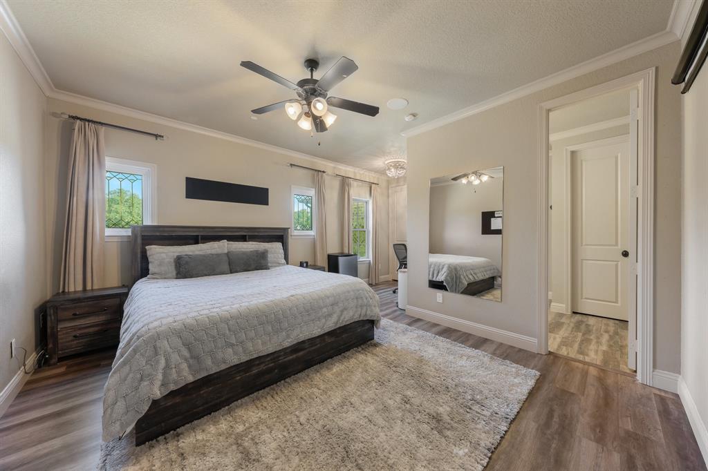 594 Turner Warnell Road Mansfield, TX 76063 - Photo 29 of 38 Bedroom with crown molding, multiple windows, a ceiling fan, and dark wood-style floors