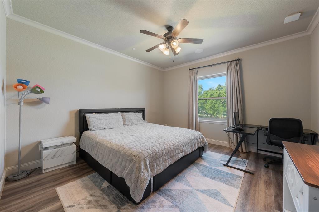 594 Turner Warnell Road Mansfield, TX 76063 - Photo 31 of 38 Bedroom featuring crown molding, wood finished floors, an office area, a ceiling fan, and a textured ceiling