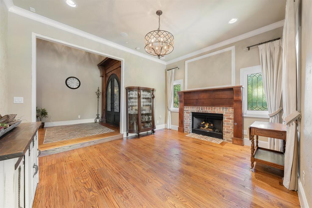 594 Turner Warnell Road Mansfield, TX 76063 - Photo 5 of 38 Dining room with ornamental molding, real hardwood flooring, a brick fireplace, recessed lighting, and a chandelier