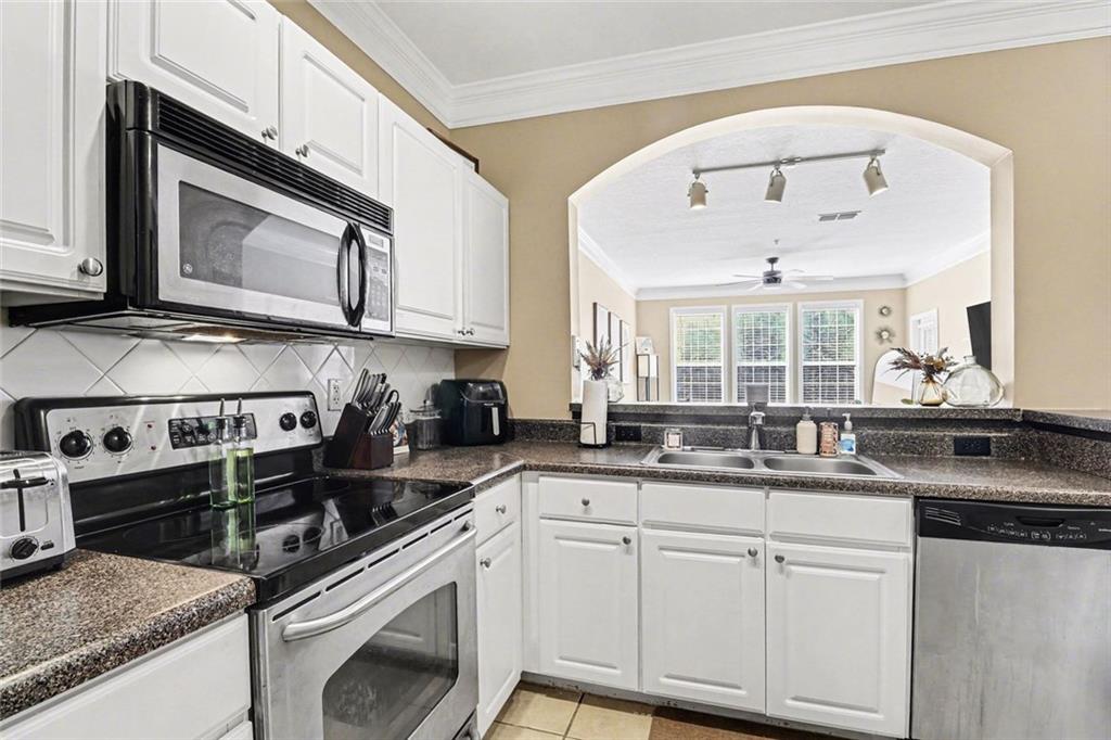 1319 Westchester Ridge Northeast Atlanta, GA 30329 - Photo 16 of 42 a kitchen with stainless steel appliances granite countertop a sink a stove and cabinets