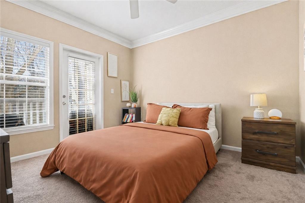 1319 Westchester Ridge Northeast Atlanta, GA 30329 - Photo 20 of 42 a bed sitting in a bedroom next to a window with a dresser