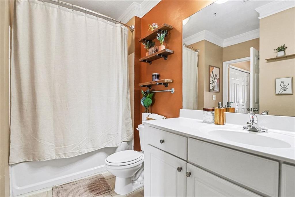 1319 Westchester Ridge Northeast Atlanta, GA 30329 - Photo 26 of 42 a bathroom with a sink a toilet and shower curtain