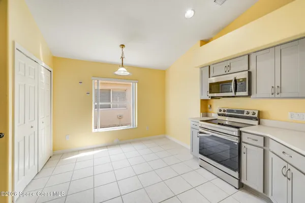 a kitchen with stainless steel appliances kitchen island granite countertop a refrigerator and a stove top oven