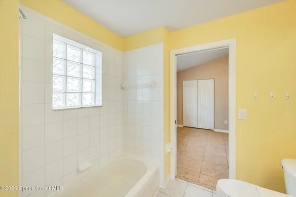 a bathroom with a bathtub and a toilet