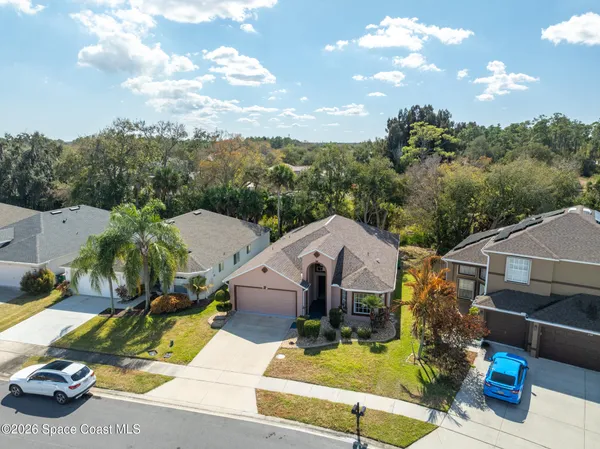 an aerial view of a house with a yard