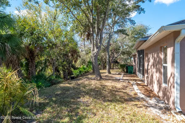 a view of a house with a tree in front of it