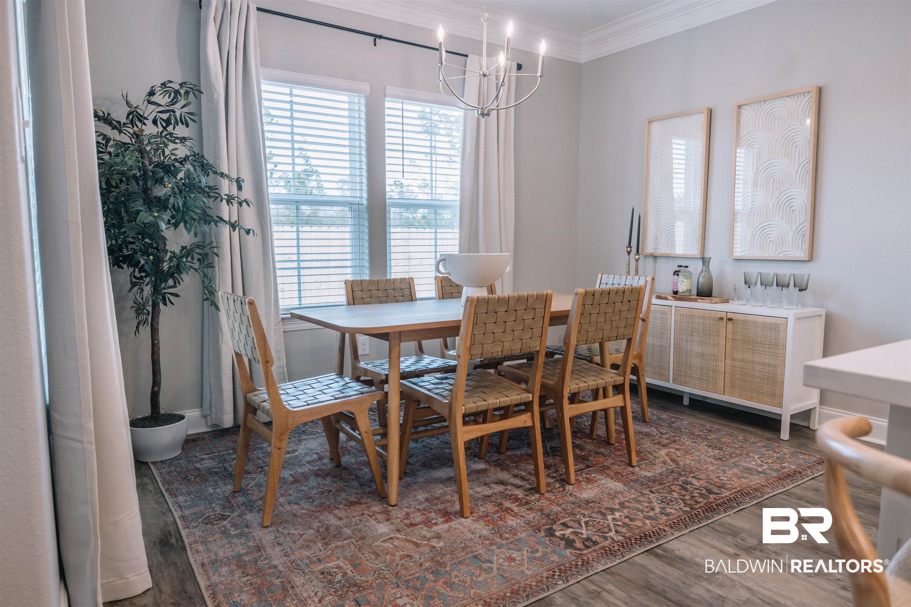 12894 Flanagan Street Elberta, AL 36530 - Photo 16 of 29 Dining area with dark wood-type flooring, a chandelier, and crown molding