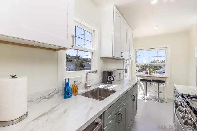 a kitchen with a sink cabinets and window