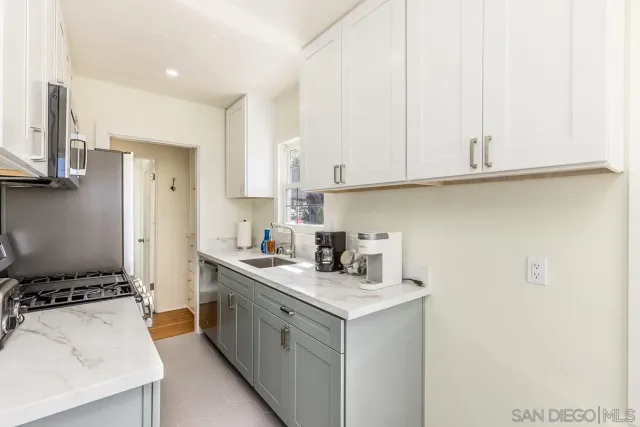 a kitchen with a sink stove and cabinets
