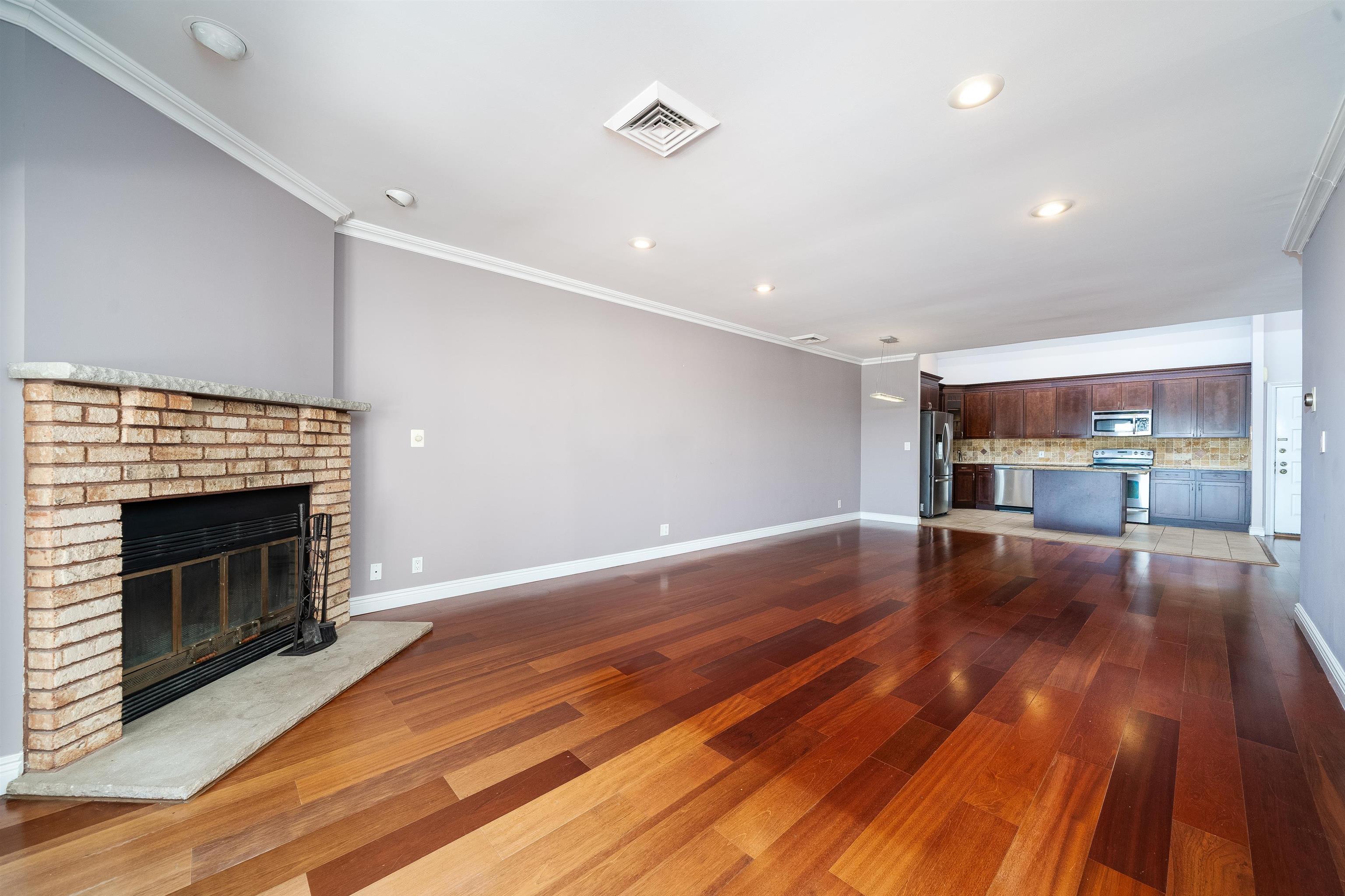 300 Gorge Road, Unit 59 Cliffside Park, NJ 07010 - Photo 2 of 14 a view of empty room with wooden floor and fireplace