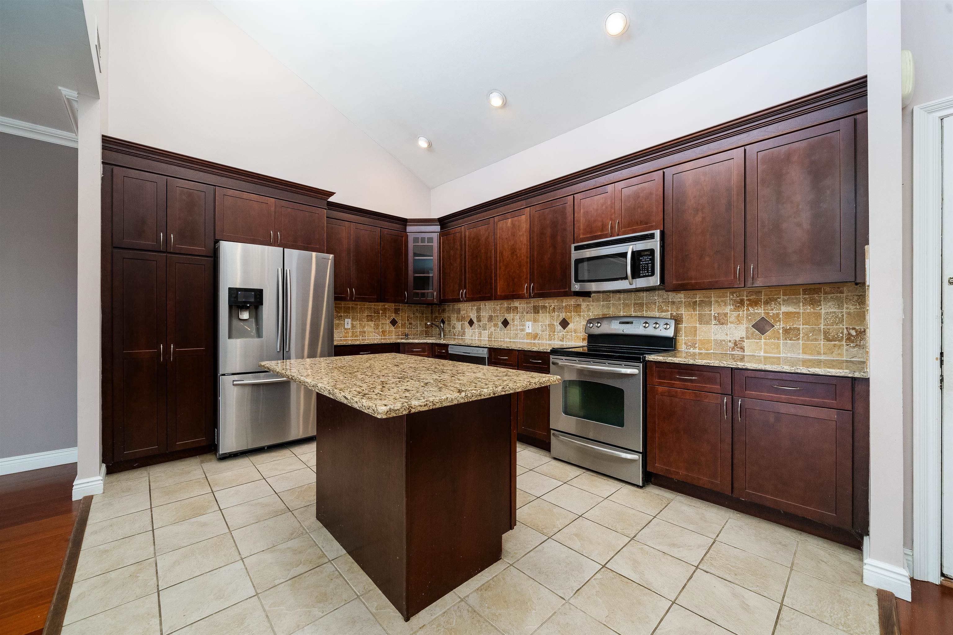 300 Gorge Road, Unit 59 Cliffside Park, NJ 07010 - Photo 3 of 14 a kitchen with stainless steel appliances granite countertop a stove top oven a refrigerator a sink and dishwasher