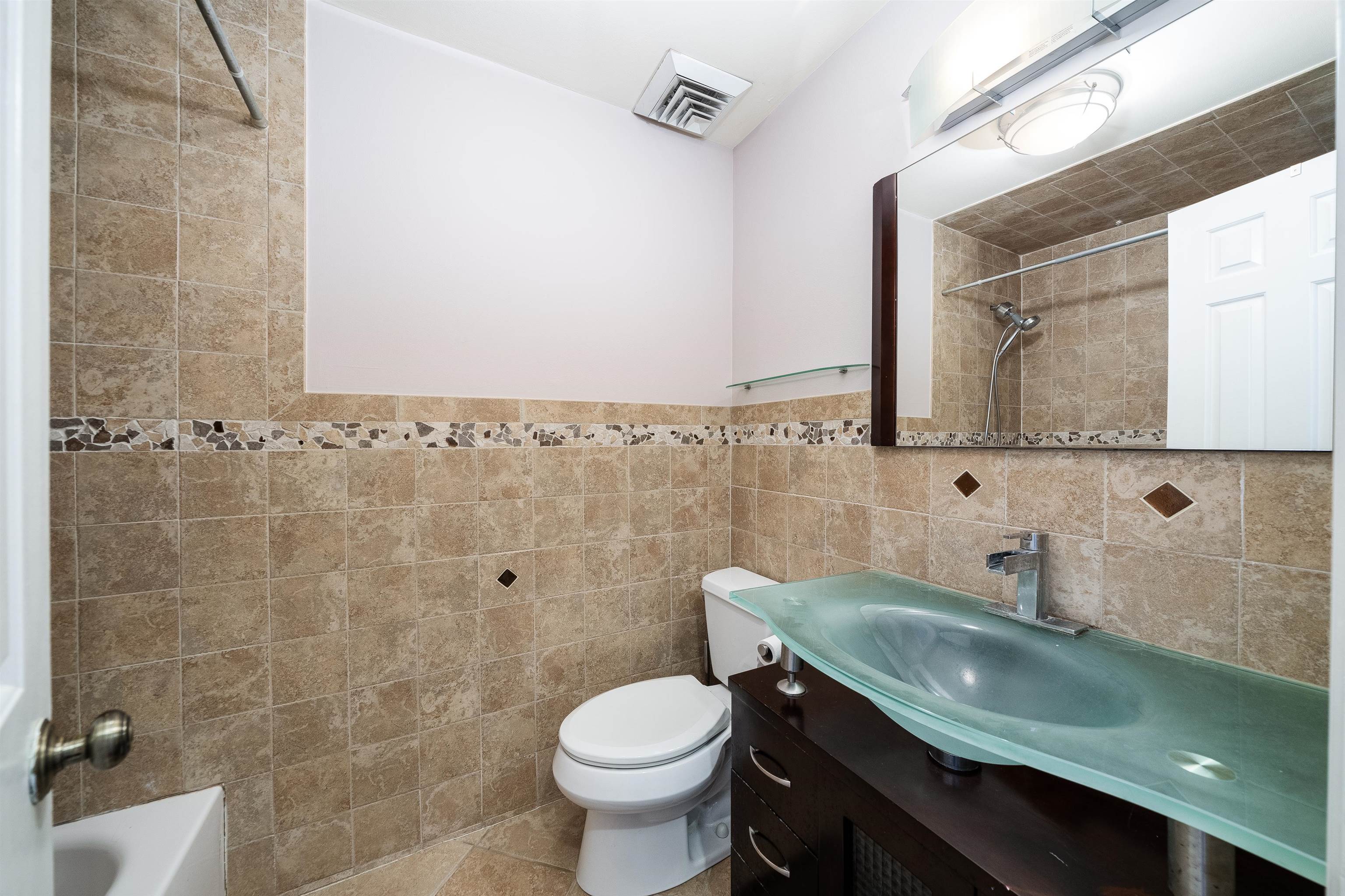300 Gorge Road, Unit 59 Cliffside Park, NJ 07010 - Photo 9 of 14 a bathroom with a granite countertop toilet sink and mirror