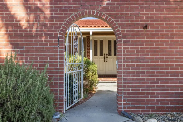 a view of a brick house with potted plants