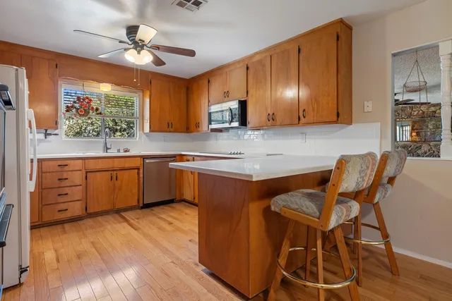 a kitchen with stainless steel appliances granite countertop a sink and cabinets