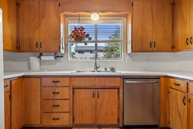a kitchen with stainless steel appliances a refrigerator and a sink