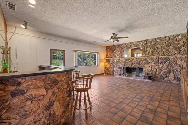 a view of empty room with a fireplace