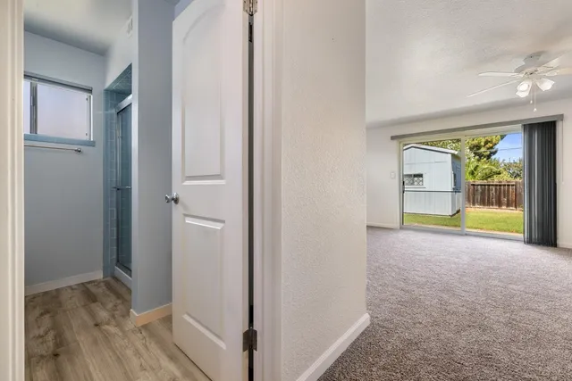 a view of an empty room with a ceiling fan