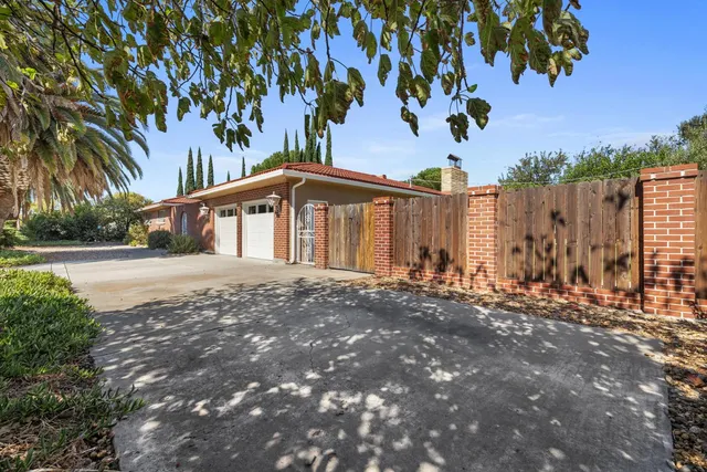 a view of a house with a tree in front