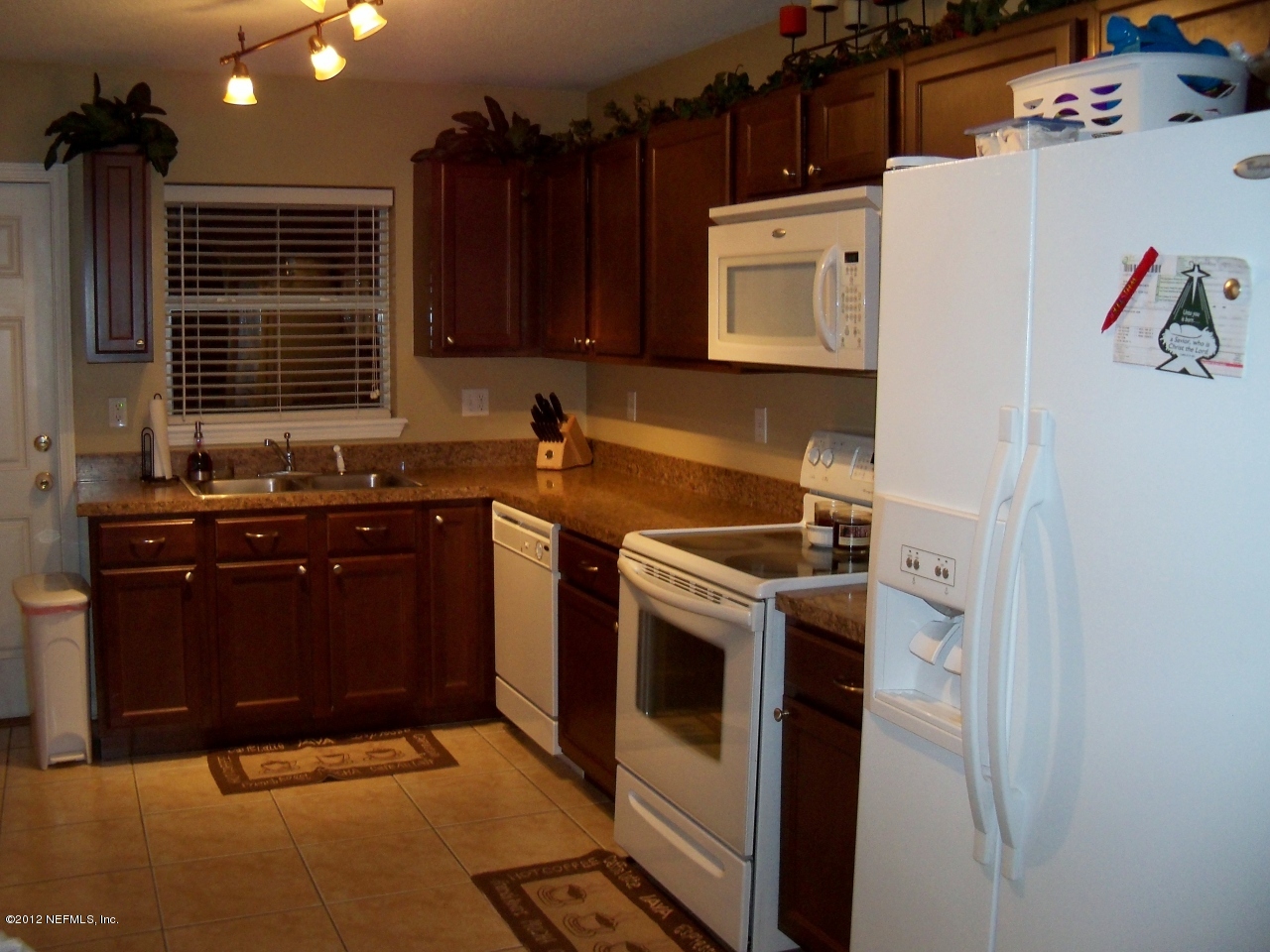9135 Raptor Drive Jacksonville, FL 32221 - Photo 3 of 15 a kitchen with a stove and a refrigerator