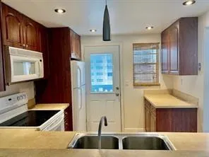 a kitchen with a sink and a refrigerator